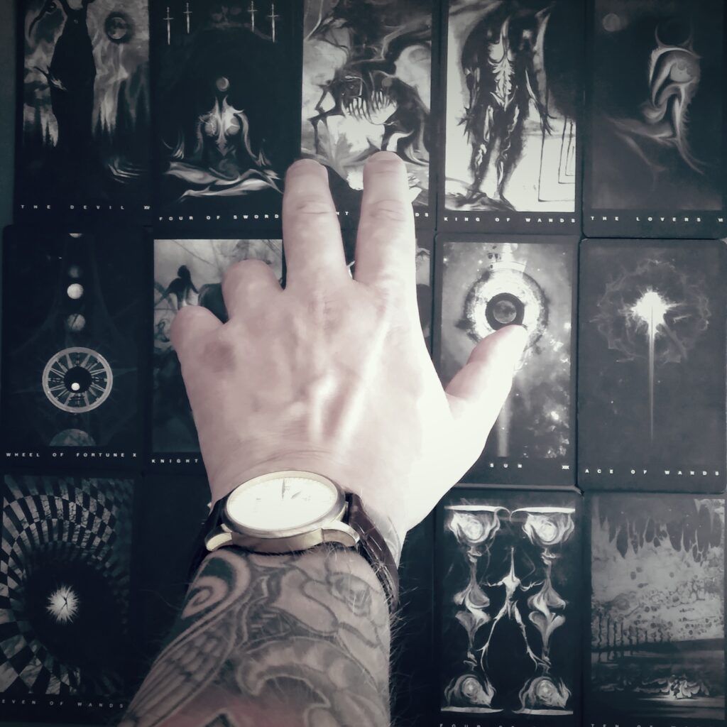 Hands holding a tarot deck in a luxurious velvet setting