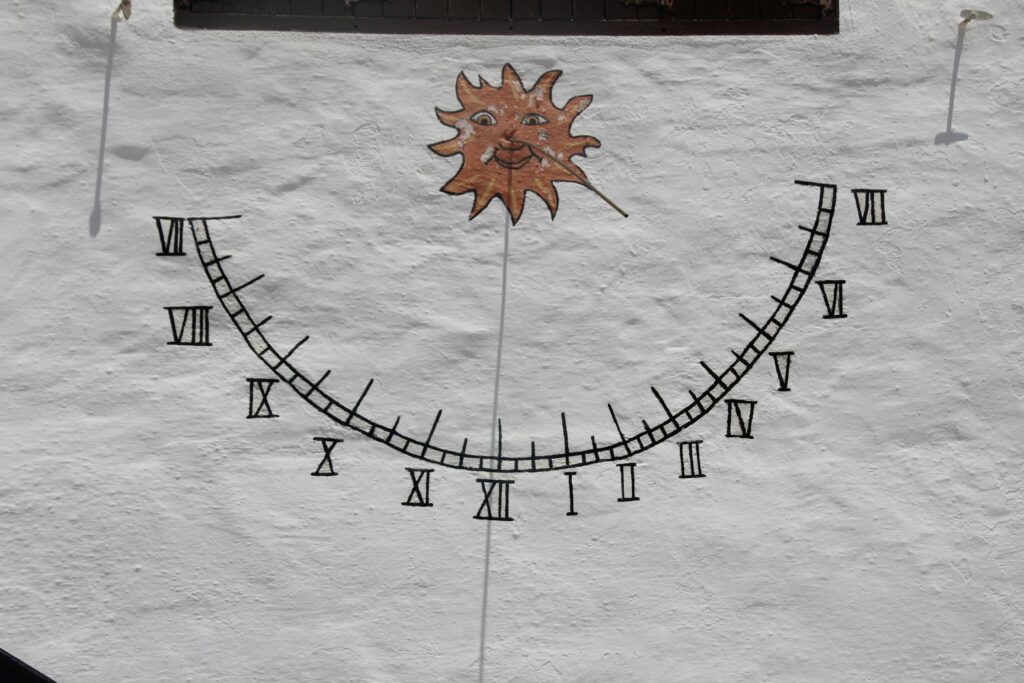 Symbols of alchemy, a crescent moon, and tarot cards arranged as an occult teaching layout